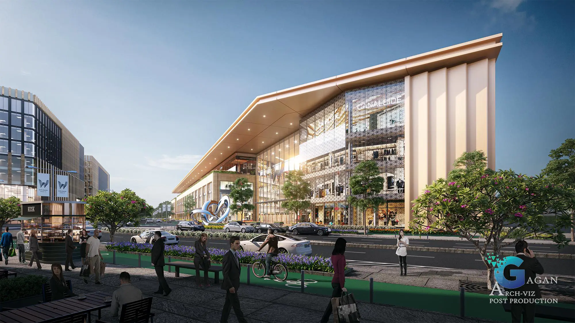 "Photorealistic 3D rendering of a modern commercial area featuring a large multi-story building with glass and structural elements. The building includes signage and storefronts, emphasizing its bustling business environment. In the foreground, an artistic sculpture adds a creative touch to the landscaped surroundings, which include trees, flowers, and pedestrian-friendly walkways. The scene also showcases several cars parked along the street, enhancing the accessibility of the space. Post-production techniques highlight realistic textures, vibrant color grading, and detailed reflections, creating a lively and professional architectural visualization