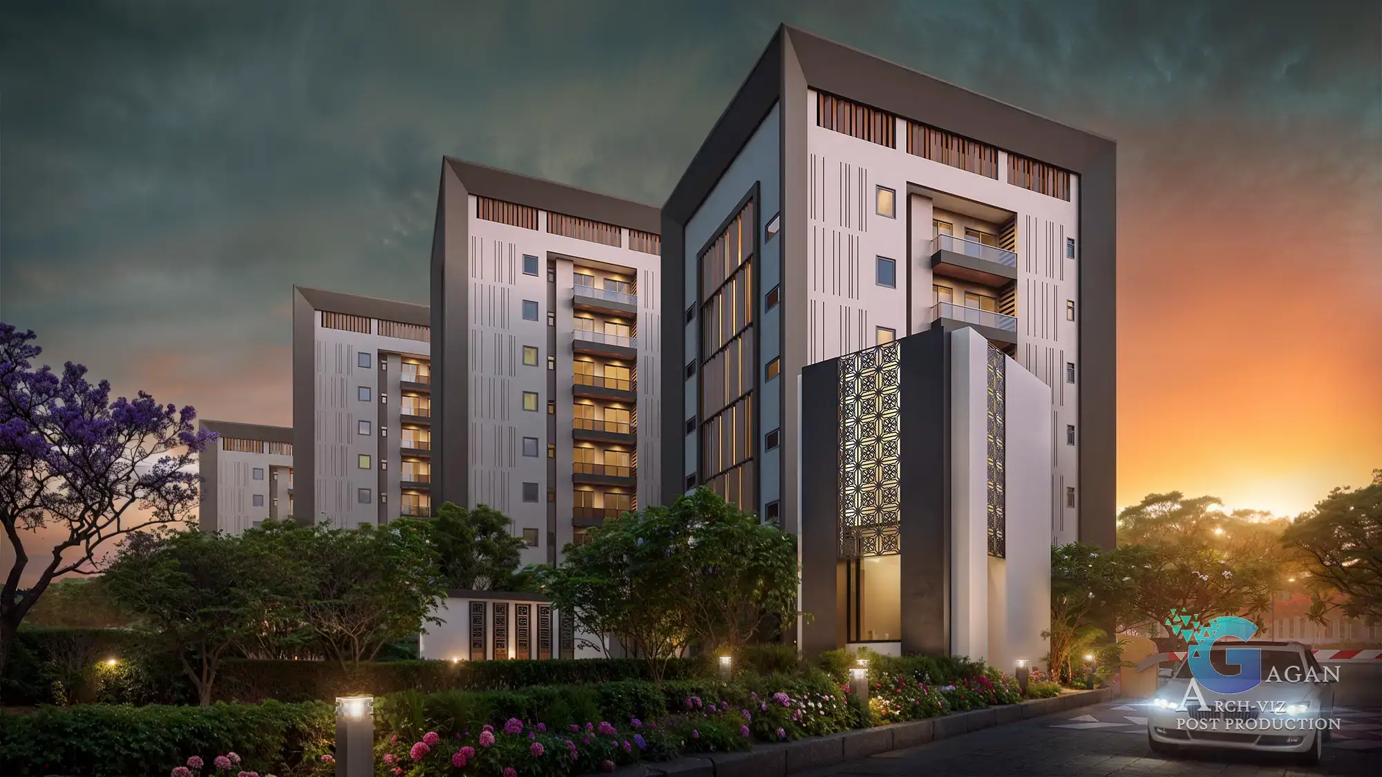 Photorealistic 3D rendering of a modern residential complex at sunset, showcasing high-rise buildings with contemporary designs, including large reflective windows, balconies, and decorative facade elements. Surrounded by landscaped greenery with trees, bushes, and illuminated pathways, post-production edits emphasize vibrant sunset lighting, realistic shadows, and enhanced textures, capturing a polished architectural visualization.